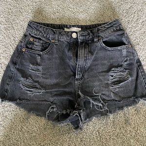 Black ripped shorts.